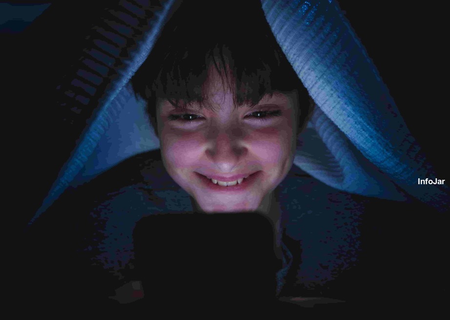 Teen Using Phone in Blanket